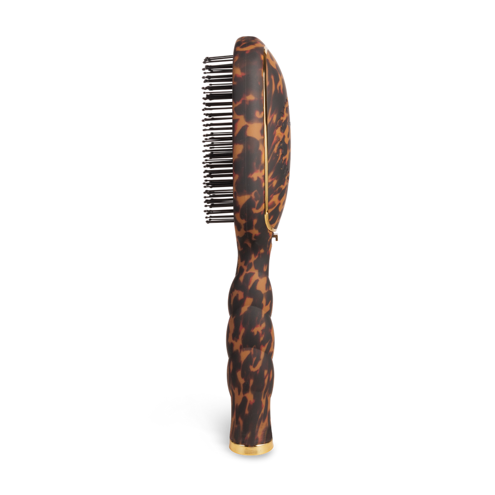The Detangler Hair Brush for Thick Hair - Tortoise has a brown and black tortoiseshell pattern, curved ergonomic handle, and black bristles. Available in multiple sizes.