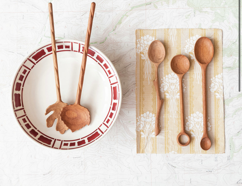Hand-carved two-sided doussie wood spoon, available in small and large sizes.