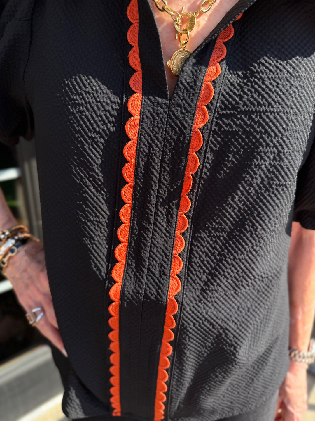 Fall in Bloom Blouse with red scallop trim. Available in sizes XS–XL.