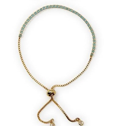 Gold adjustable bracelet with light blue stones, two chain ends, round charms; available in S/M and M/L.
