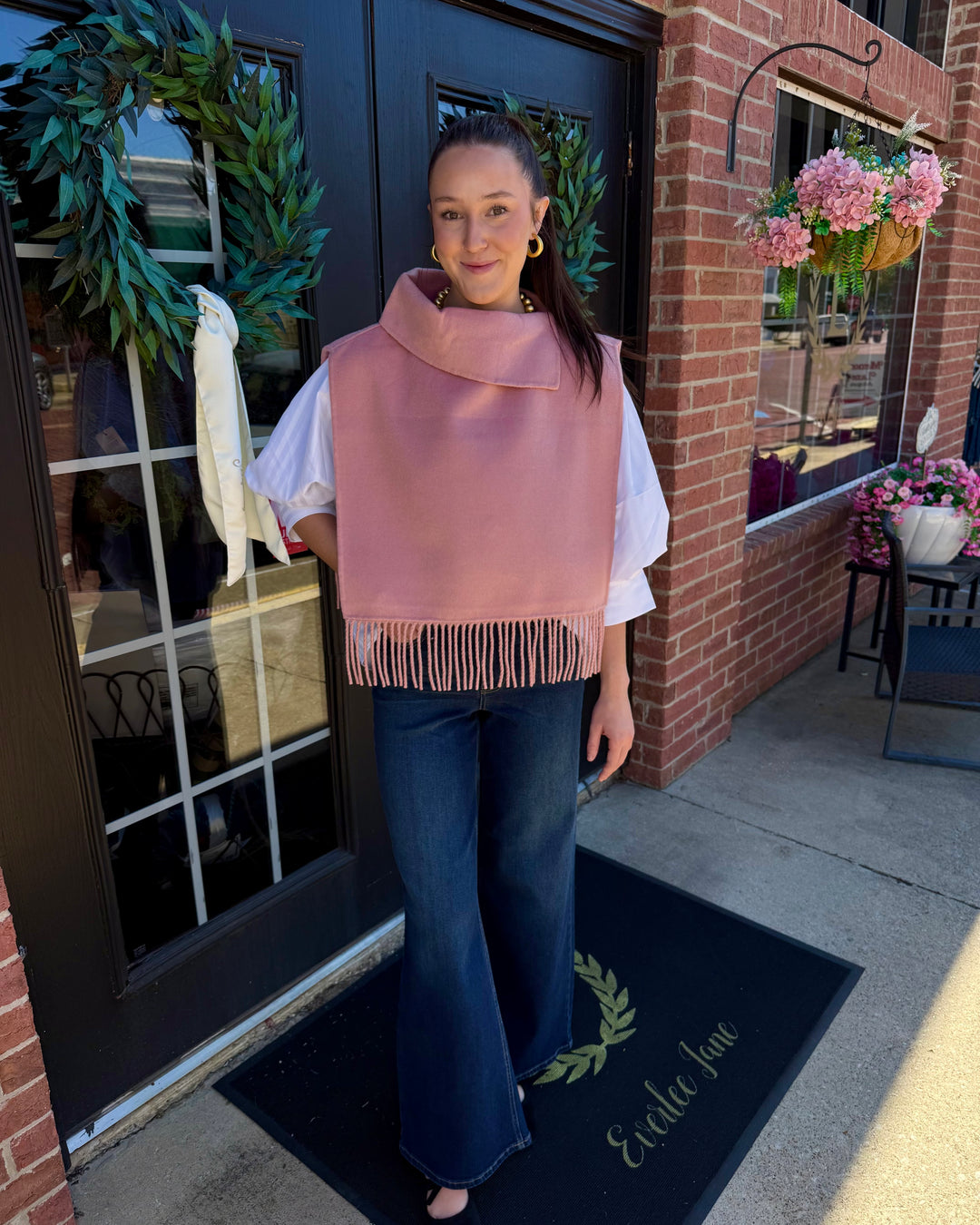 Blush pink collar poncho with fringe hem.