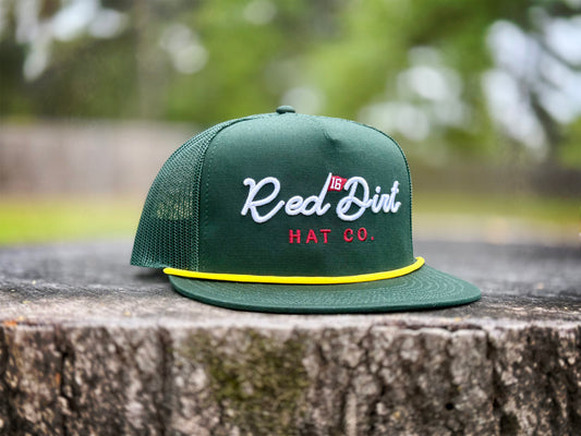 Green mesh trucker golf hat with "Red Dirt Hat Co." embroidery, yellow cord above brim. Available in S/M, L/XL.