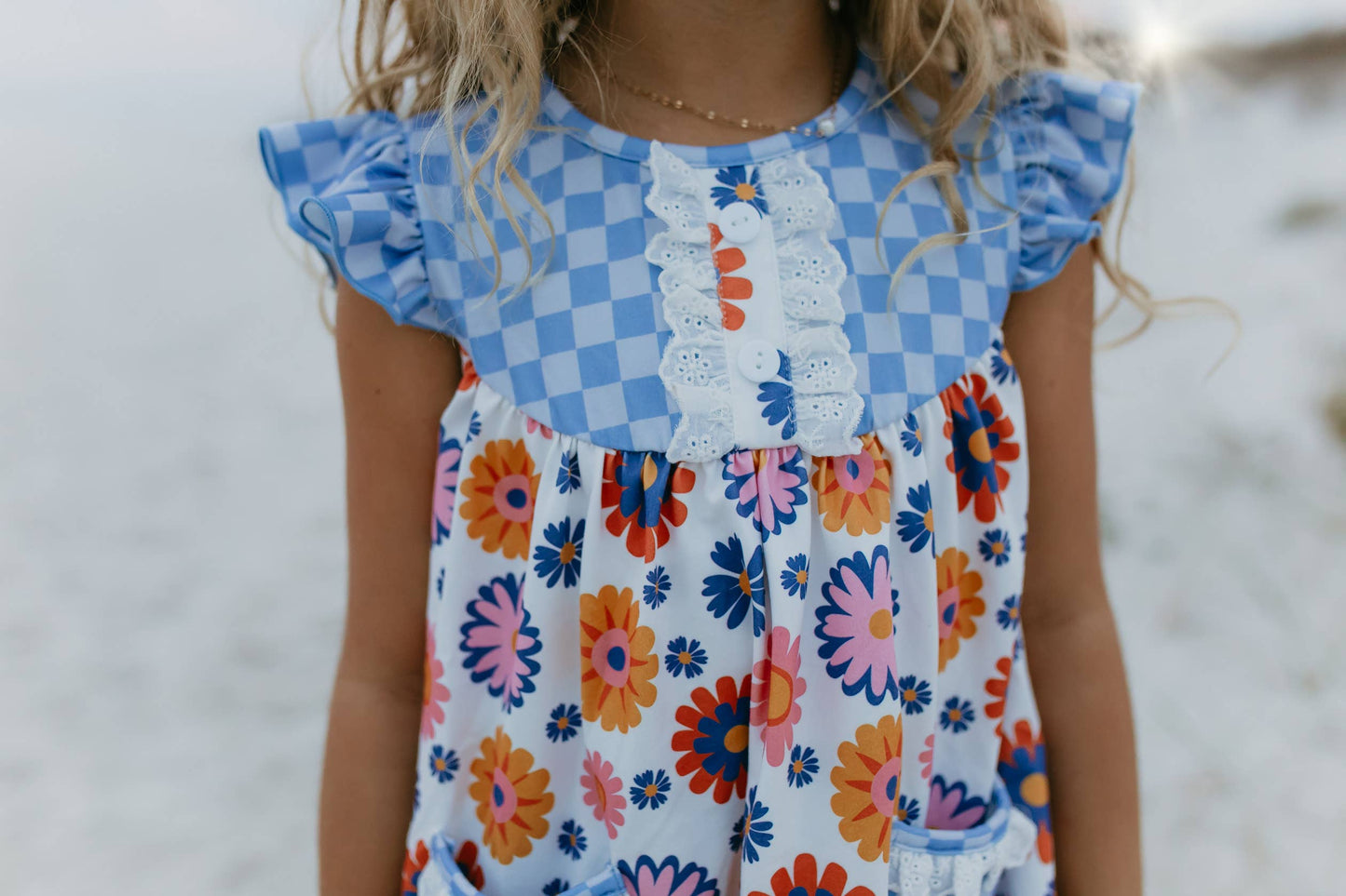 Girls Blue Check Flower Power Short Set with ruffled sleeves and retro floral shorts. Available in sizes 2T-8.