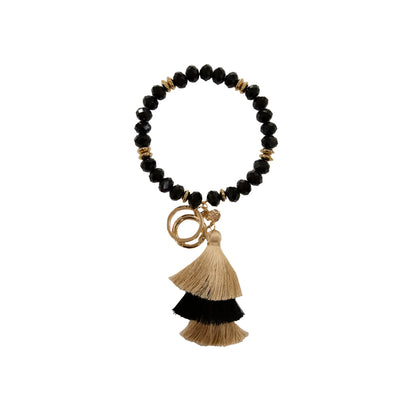Bead Bangle Crystal Keychain with black beads, gold spacers, tassel charms, and gold rings. Available in one size.