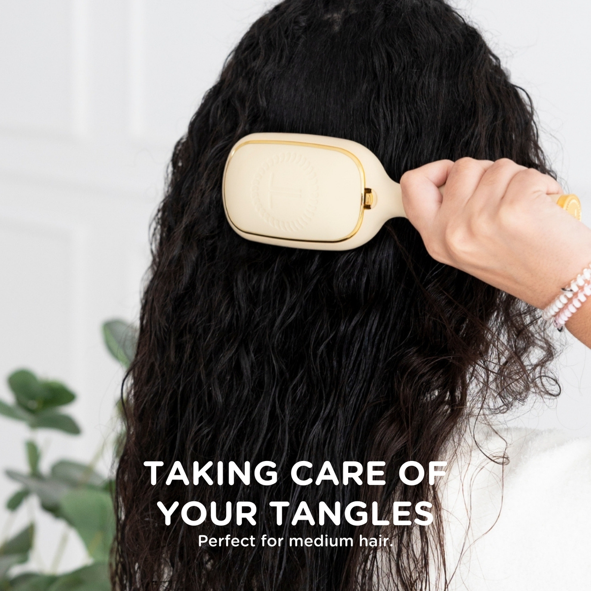 Detangler Hair Brush for Medium Hair in tan. Available in medium size. Text reads: “Taking care of your tangles. Perfect for medium hair.”.