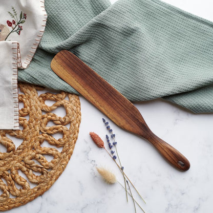 Spatula with a sleek handle, available in 10-inch and 12-inch sizes.