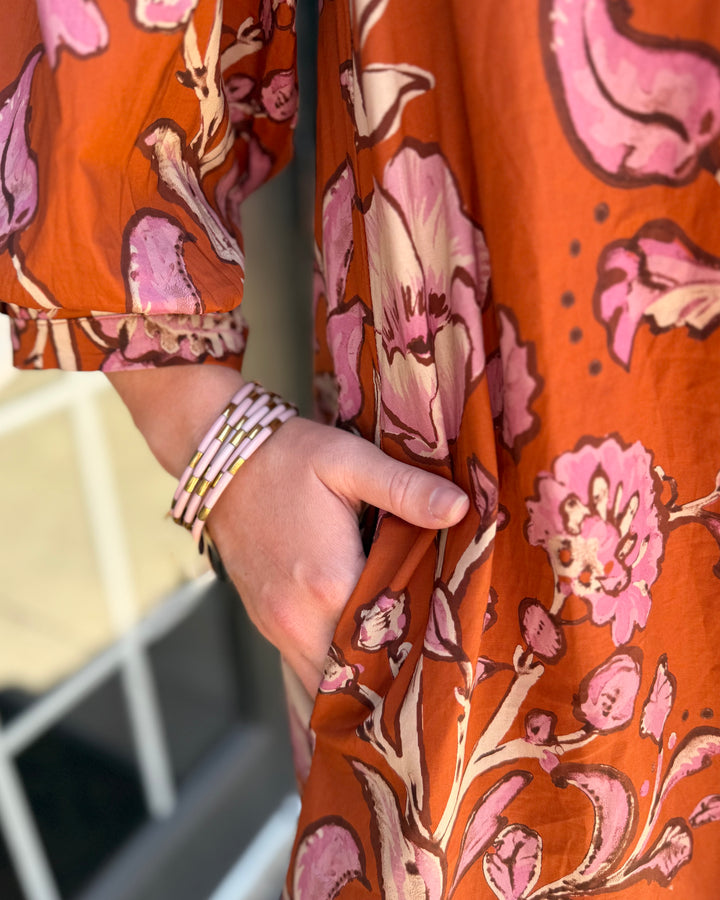 Autumn Rust Long-sleeve Dress, available in sizes XS-XL, features sunlit rust-colored fabric with a relaxed fit and side pocket.