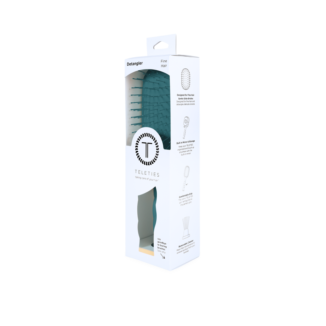 A Detangler Hair Brush for Fine Hair - Teal With It is shown in sleek white TELETIES packaging with a window displaying the gentle bristles. Available sizes: Not specified.