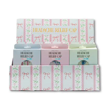 Headache Relief Cap in blue, pink, and green pastel packages with pink bows; sizes S, M, L. For migraine or sinus relief.