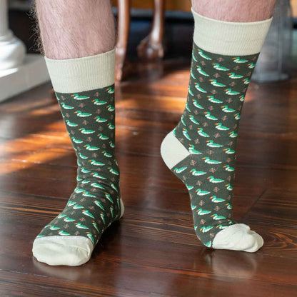 Green Men’s Socks with white toes, heels, and cuffs, red-hatted bird pattern, subtle stars/stripes. Sizes: S-XL.