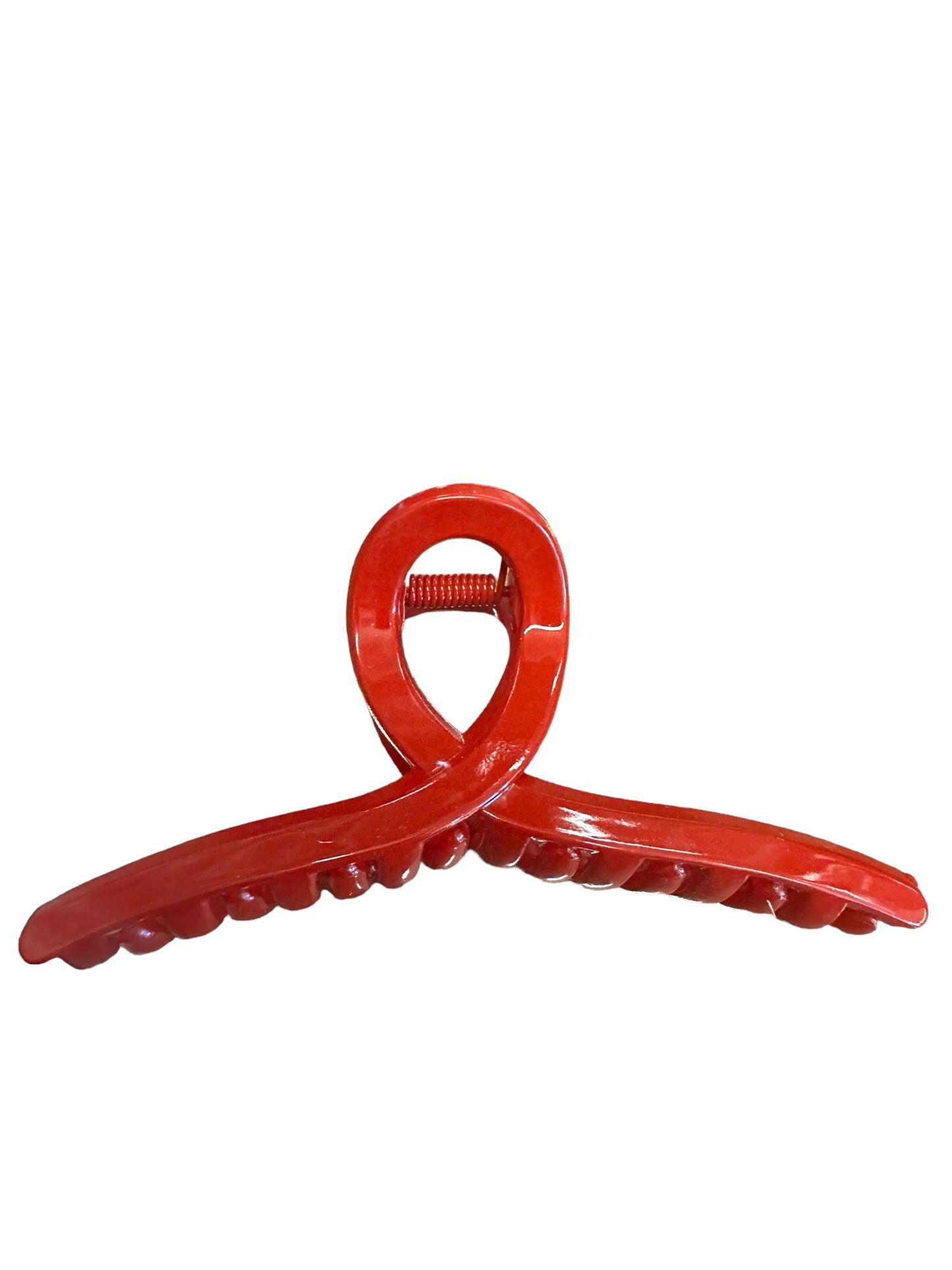 Red plastic 4th of July Claw Clips with interlocking teeth and spring mechanism for holding hair. Glossy finish, loop at top for easy grip. Sizes available: Medium