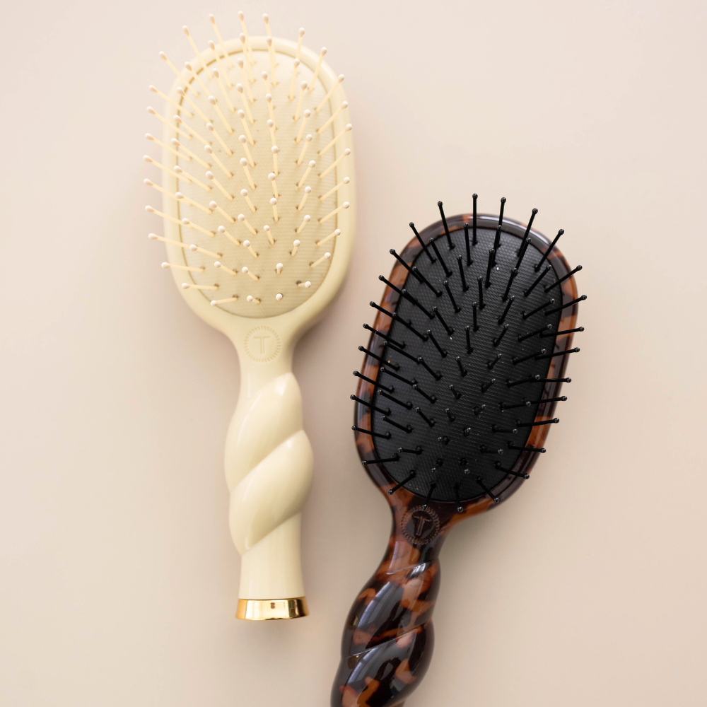 Mini Detangler Brush for Medium Hair in Tan features a twisted handle and cushioned bristle pad. Available in mini size.