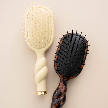 Mini Detangler Brush for Medium Hair in Tan features a twisted handle and cushioned bristle pad. Available in mini size.