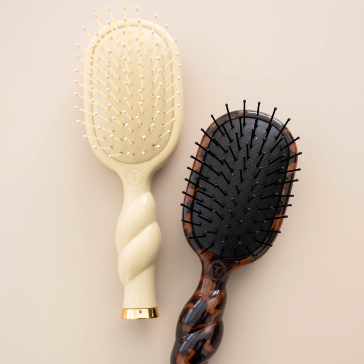 Mini Detangler Brush for Medium Hair in Tan features a twisted handle and cushioned bristle pad. Available in mini size.
