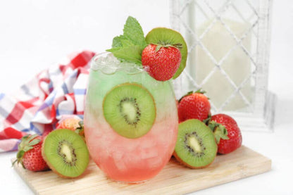 Vibrant glass with green and pink layers, kiwi, strawberry, and mint garnish. Adult Slush Drink Pouches. Available in multiple sizes.