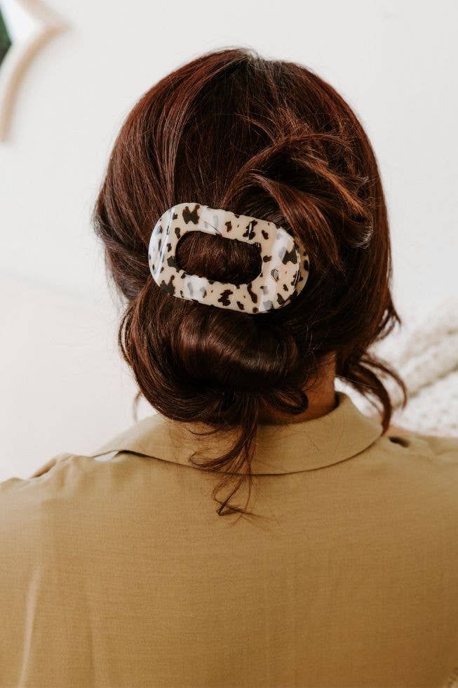 TELETIES Flat Round Hair Clip in white and brown tortoiseshell; available in small, medium, and large sizes.