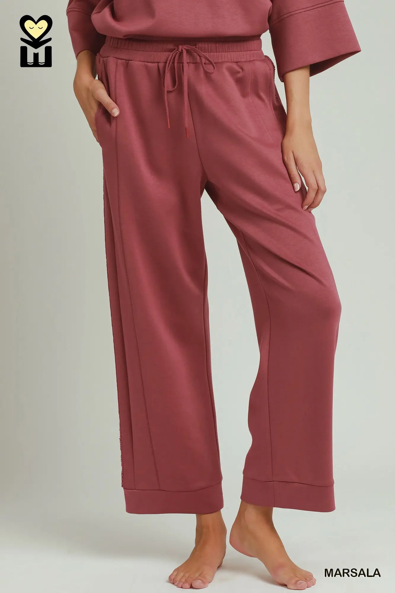 Loose-fitting, marsala-colored Butterfly Lace Straight Leg Pants. Available in sizes XS–XL.