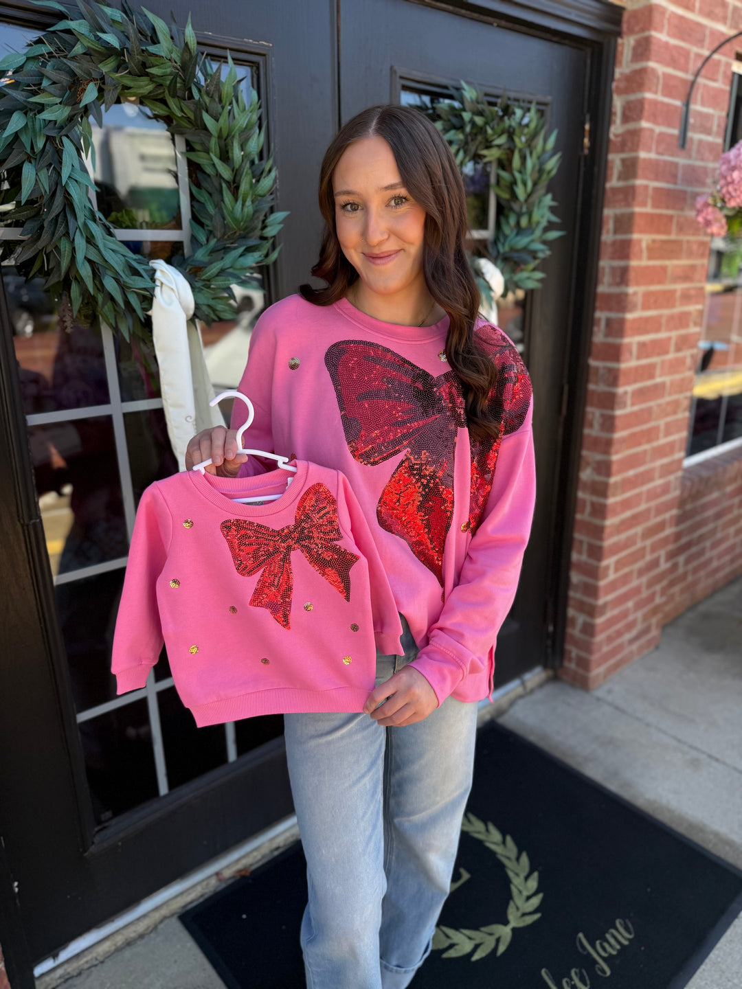 Pink French Terry sweatshirt with red sequin bow, available in adult and child sizes.