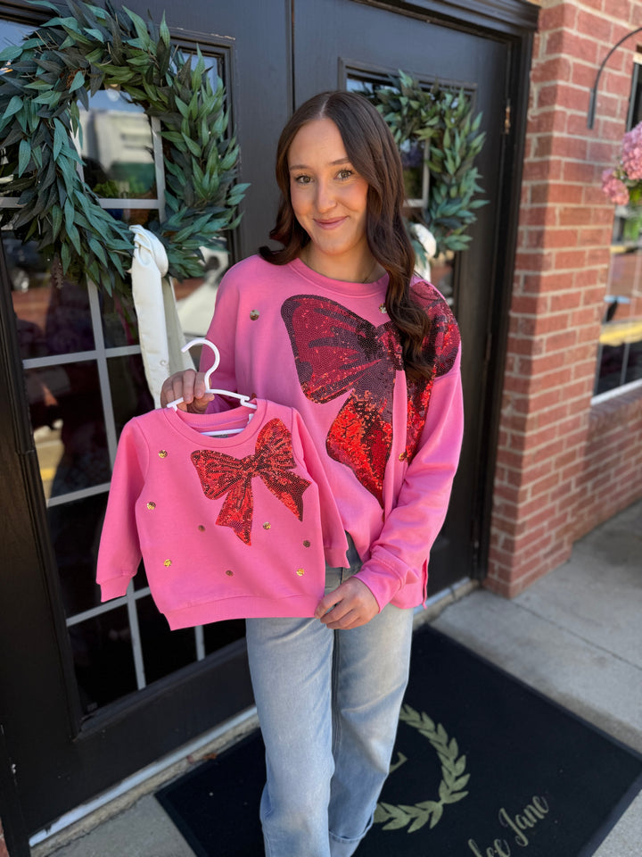 Pink French Terry sweatshirt with red sequin bow, available in adult and child sizes.
