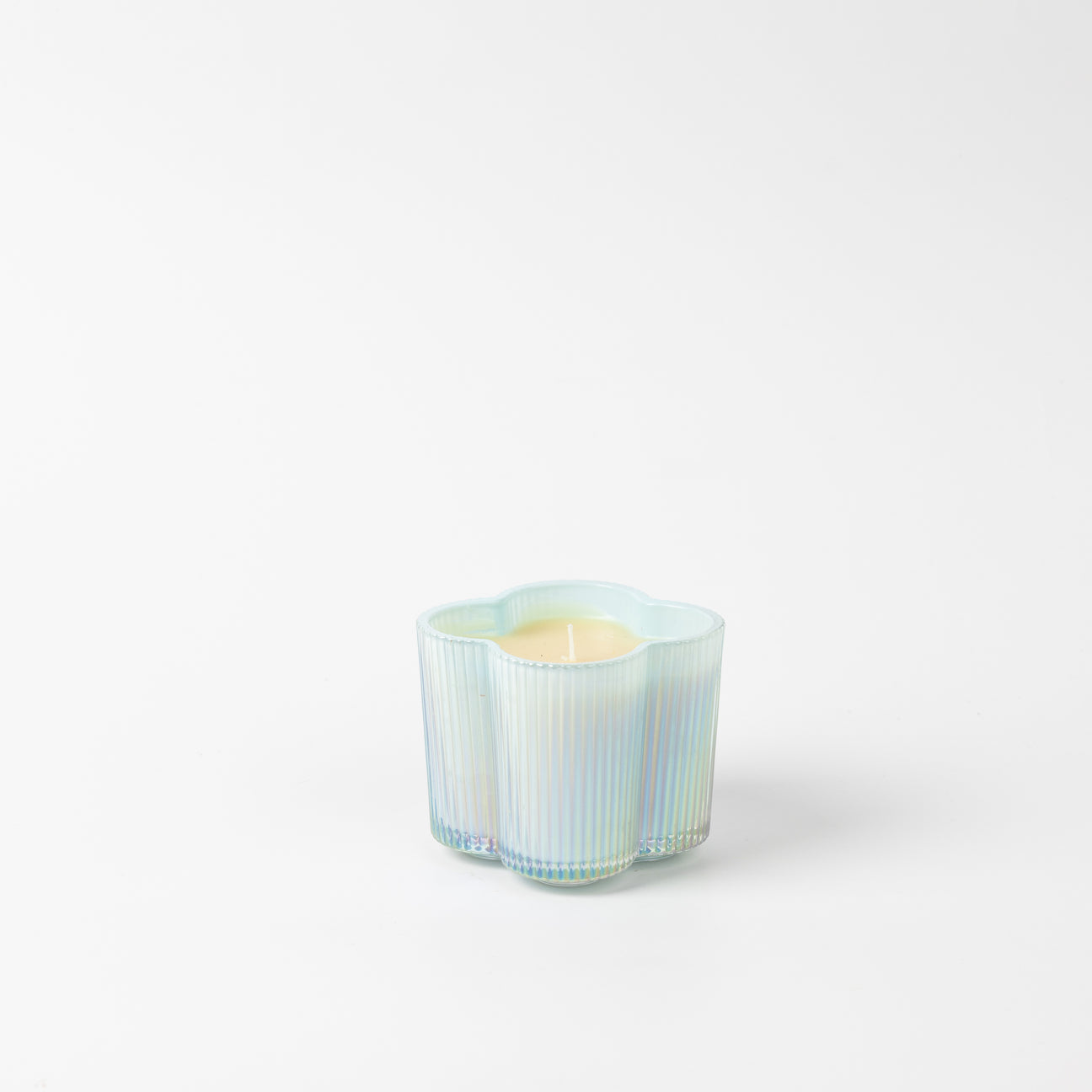 Sweet Grace Collection Flower Candle 7.2 oz, light yellow in an iridescent, wavy, flower-shaped glass holder.
