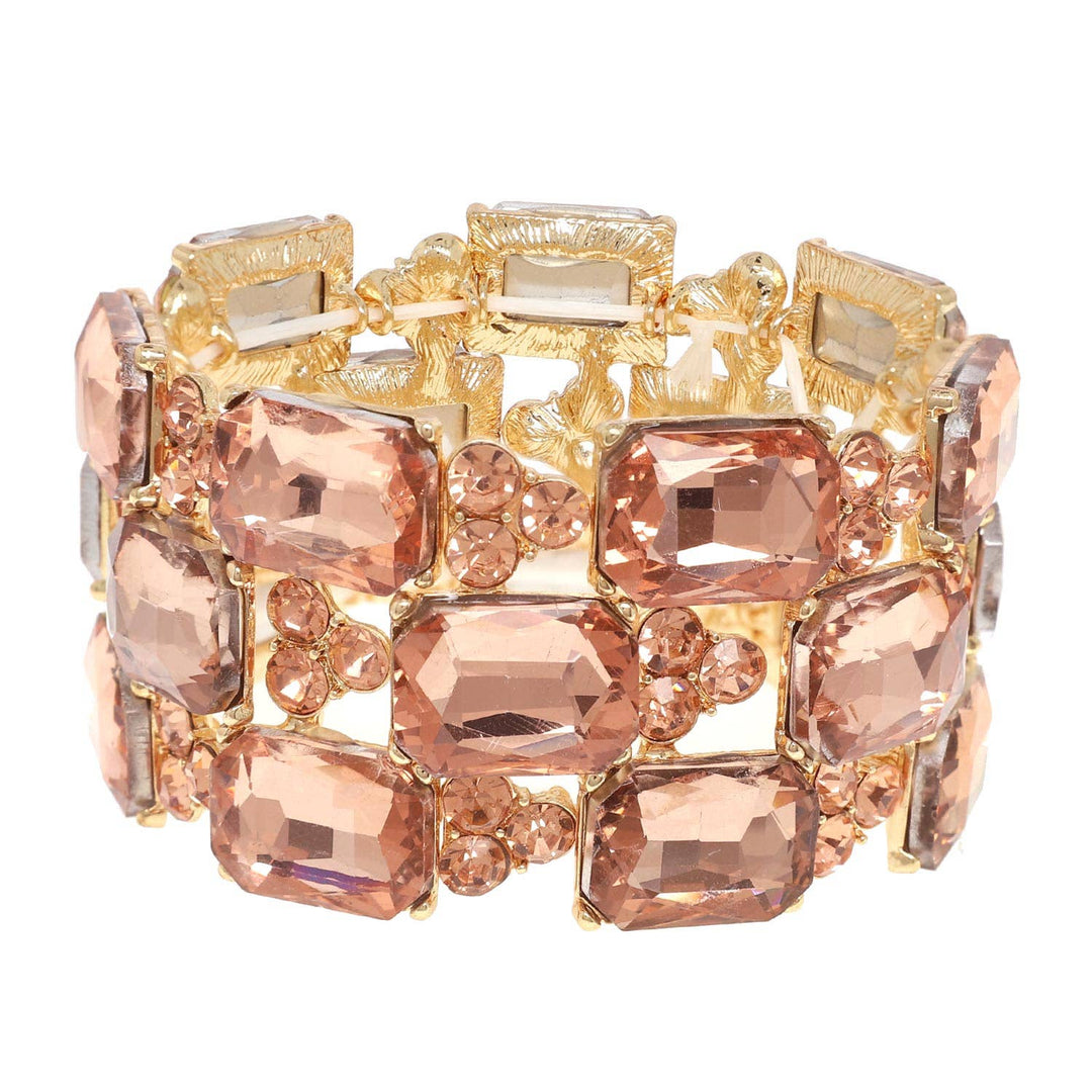 Gold bracelet with large peach rectangle crystals and small round stones. Available in sizes S, M, and L.