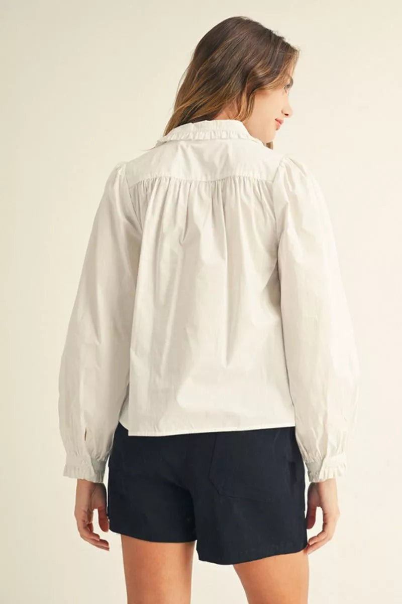 Off-White Ruffle Collar Button-Up Blouse with puffed long sleeves. Available in sizes XS–XL.