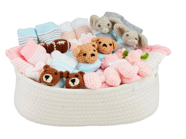 White woven basket of pink, blue, and gray baby socks with bear/elephant faces. Sizes: 0-6M, 6-12M, 12-24M.