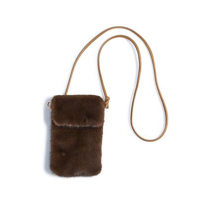 Small brown faux fur mini crossbody bag with long tan strap; available in one size.