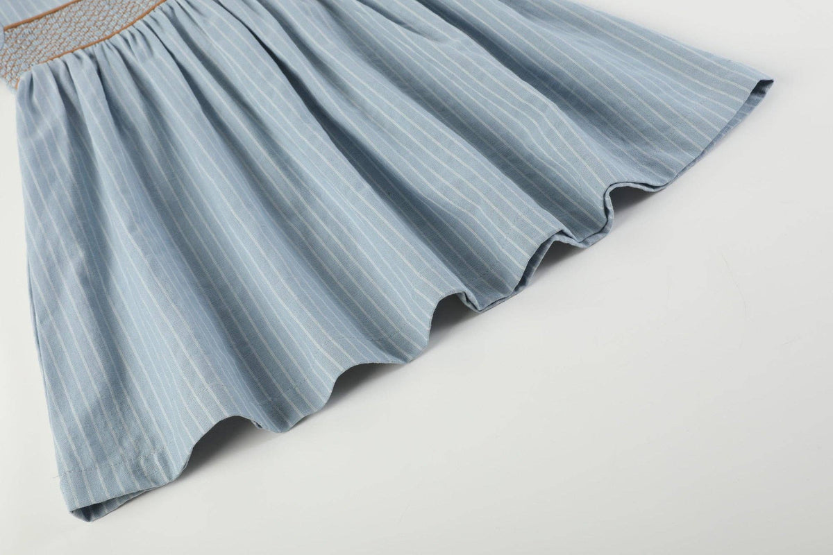 Blue Pinstripe Brown Smocked Ruffle Collar Dress with vertical blue and white pinstripes, brown smocked detailing, and a ruffle collar. Available in size 18-24M.
