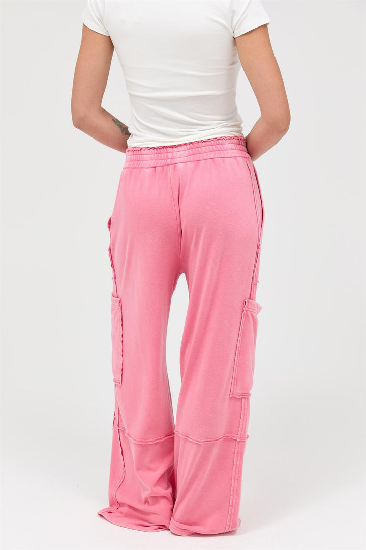 Wide-leg pink Mineral Wash Cargo Pants with side pockets. Available in sizes XS–XL.