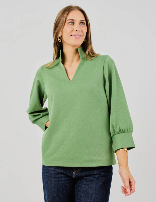 Jocelyn Green Top with V-neck, 3/4 sleeves, and standing collar. Available in sizes XS-XL.