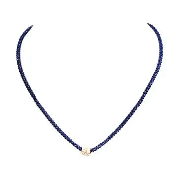 The Cassie Kentucky Blue Necklace has a thin, blue woven snake chain with a small, round diamond accent bead at the center. Available in 16", 18", and 20" lengths.