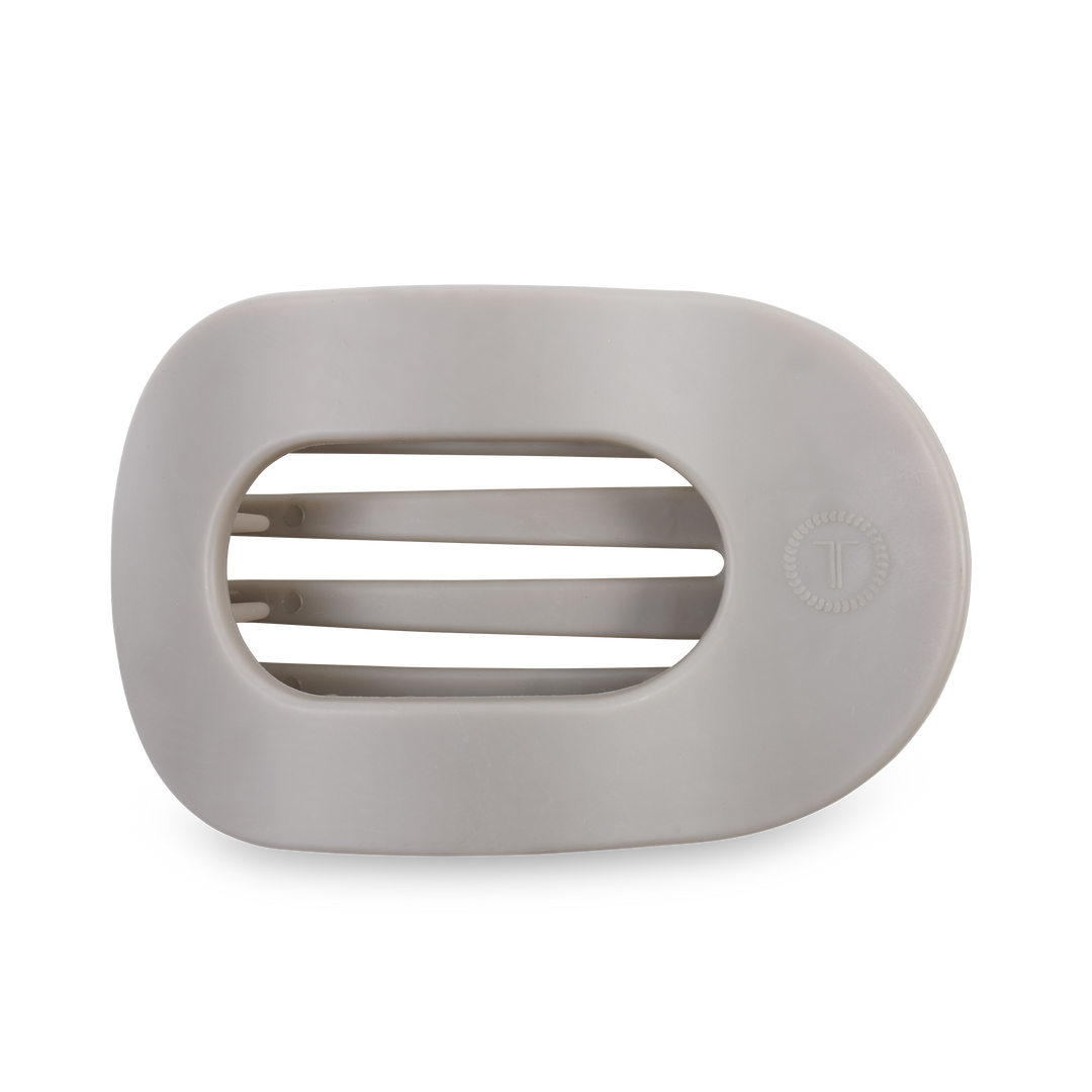 White oval soap dish with three drainage slats and a small circular logo on the right. Sizes available: small, large.