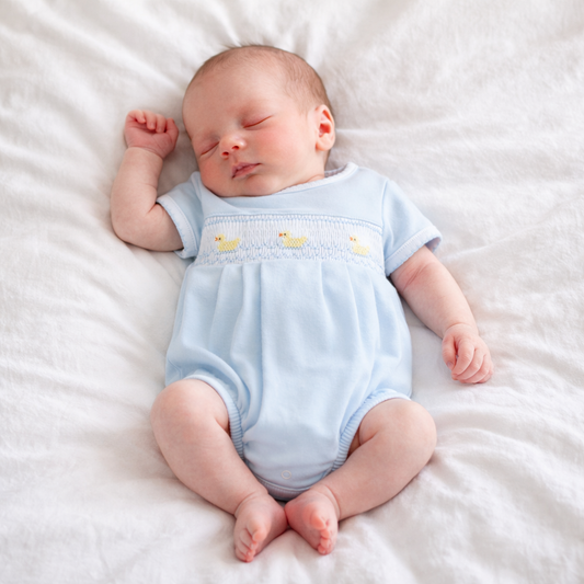 Little Ducklings Classics Smocked Bubble, Light Blue, hand-embroidered ducklings on chest. Available in newborn sizes.