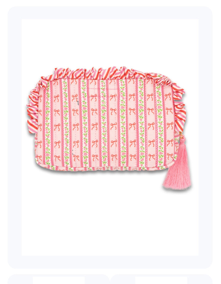 Quilted Cosmo Bag by Simply Southern: pink rectangular pouch with ruffles, stripes, bow, green accents, pink tassel. Sizes: S/M/L.