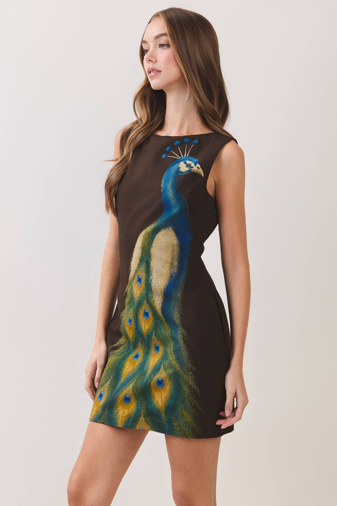 CD07499-Peacock Print Mini Dress in CHOCOLATE, sleeveless, fitted silhouette with vibrant peacock design. Available in size M.