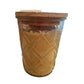 Clear, diamond-patterned glass jar with a smooth wooden lid. Contains Pumpkin Caramel Drizzle Candle made from soybean wax. Sizes available: 8 oz, 16 oz.