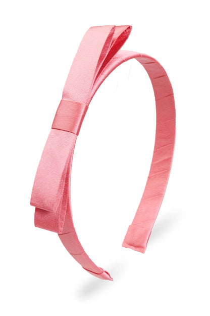 Pink satin Sloane Mini Bow Headband with bow on one side. Available in mini size only.