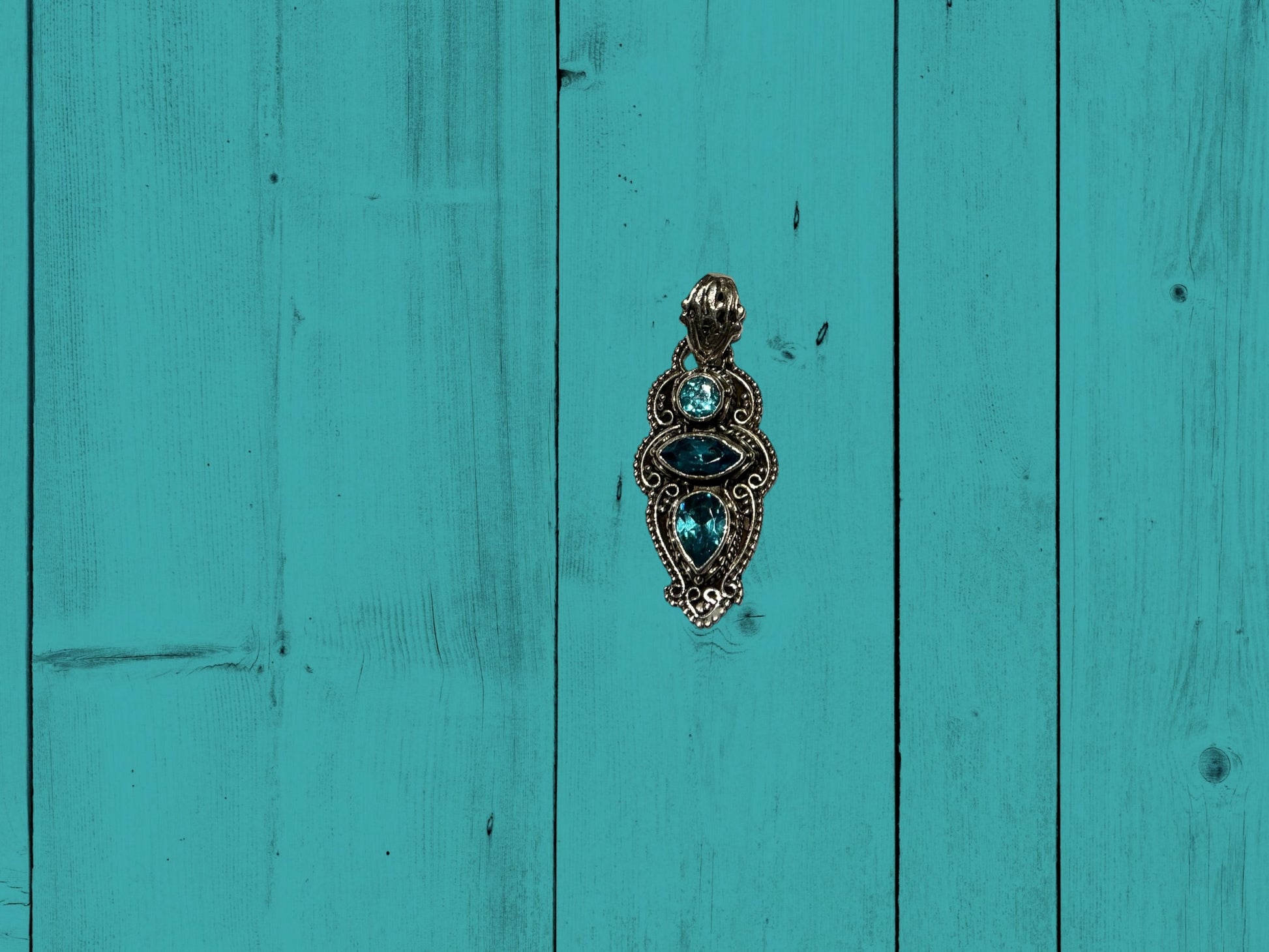 Decorative metal door knocker with blue stones, vintage-inspired. Available in small, medium, and large sizes.