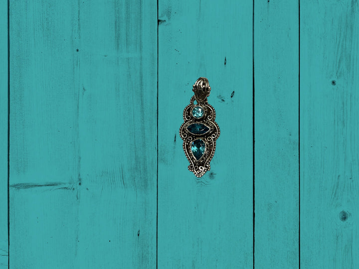 Decorative metal door knocker with blue stones, vintage-inspired. Available in small, medium, and large sizes.