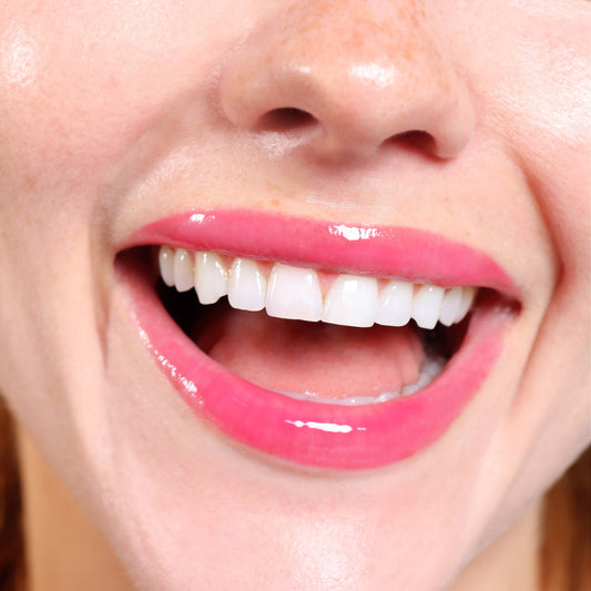 Berry Bliss Tinted Lip Balm with peptide & shea butter shown in use; available in 0.13 oz and 0.25 oz sizes.