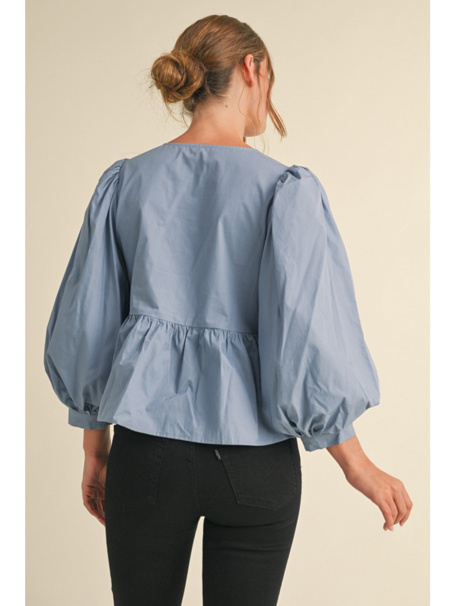 Bow Tie Peplum Top in light blue with balloon sleeves and a slightly flared hem. Sizes available: S, M, L.