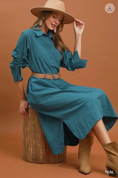 Teal Collared Button Detail Relaxed Midi Dress with long sleeves, tan belt; cotton. Available in sizes XS-XL.