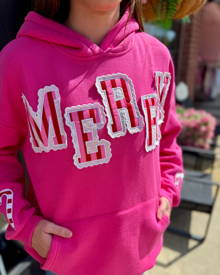 Bright pink Striped Scallop Merry Hoodie with “MERRY” in bold white and red letters. Available in sizes XS–XXL.