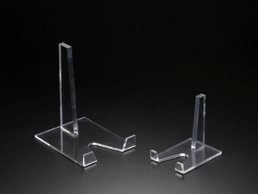 Two clear 5" H plate stands. Features upright support and flat base with notch for holding items. Available as a set with one larger and one smaller stand, suitable for 5" H plates.