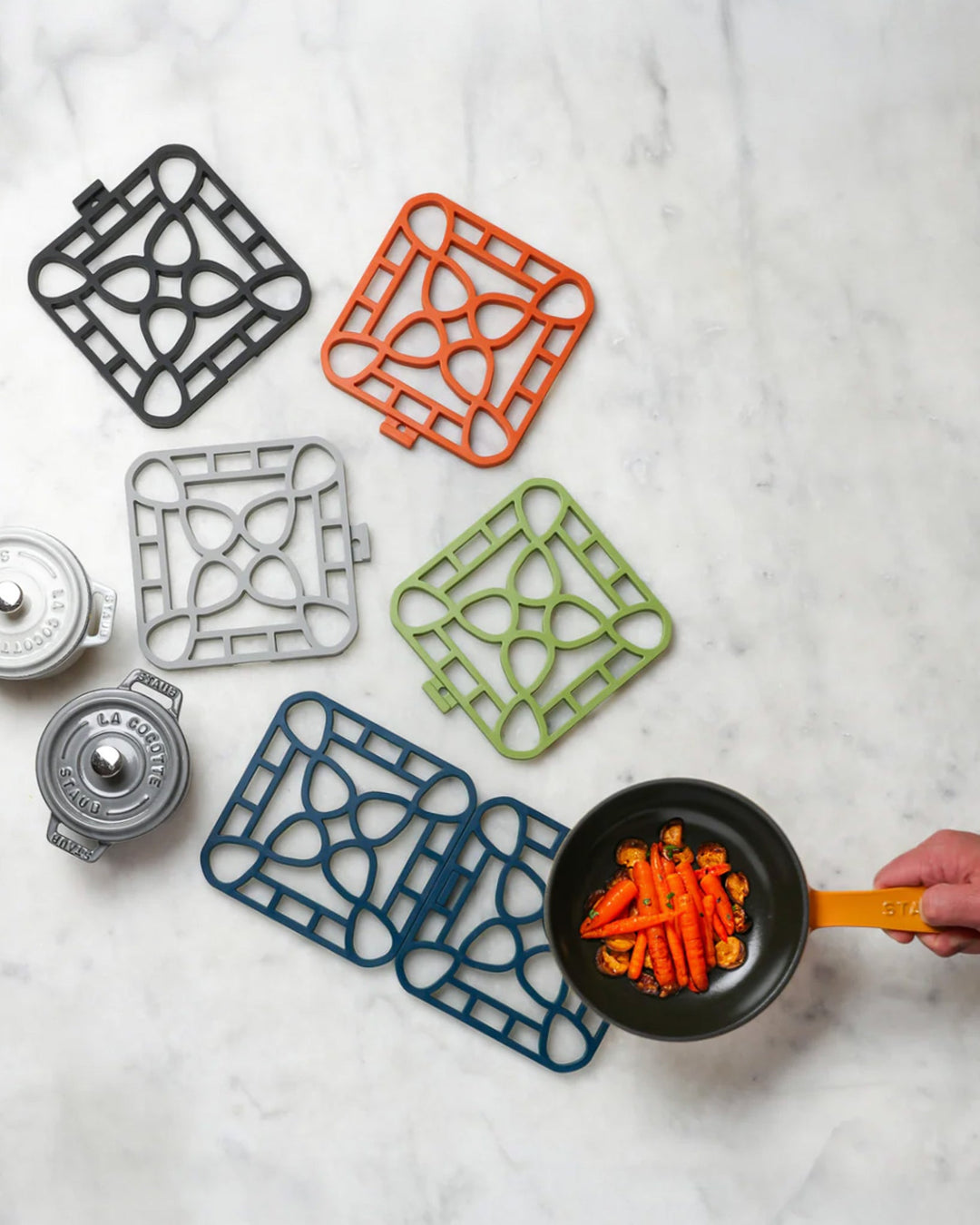Colorful, floral-patterned Interlocking Trivets shown; available in multiple sizes.