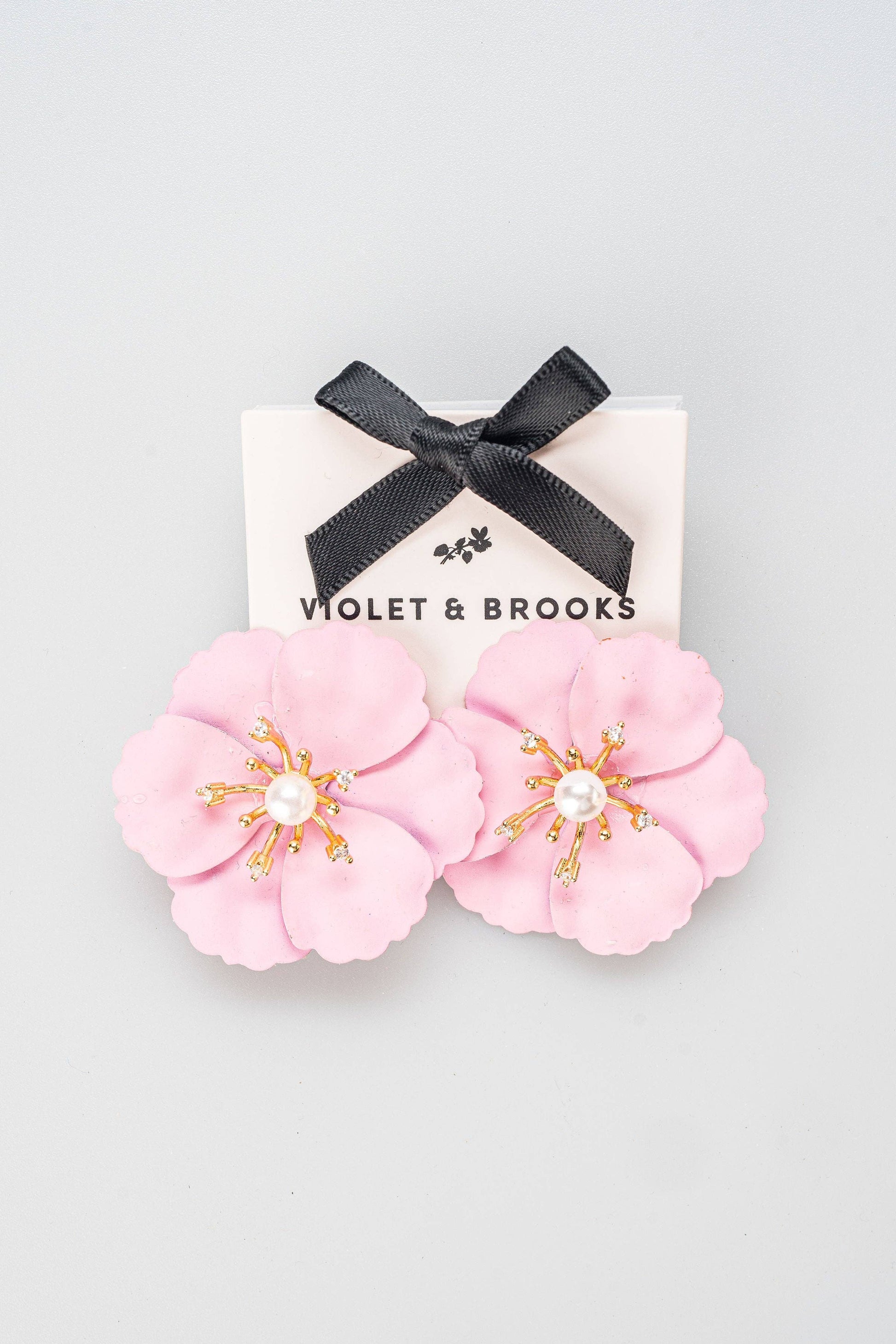 Pink flower-shaped statement earrings with gold-plated accents, pearl center. Available sizes: one size fits all.