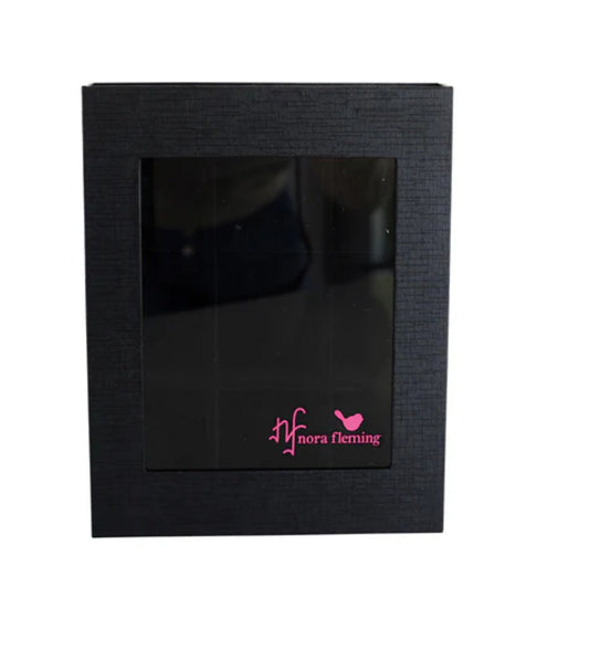 **Keepsake Box Holds 9**

A black storage box with a transparent front window. Showcases a dark interior, ideal for organizing miniatures. Features a pink "nora fleming" logo with an "nf" and bird silhouette on the lower-right corner of the window.

**Sizes Available:** Information not provided.