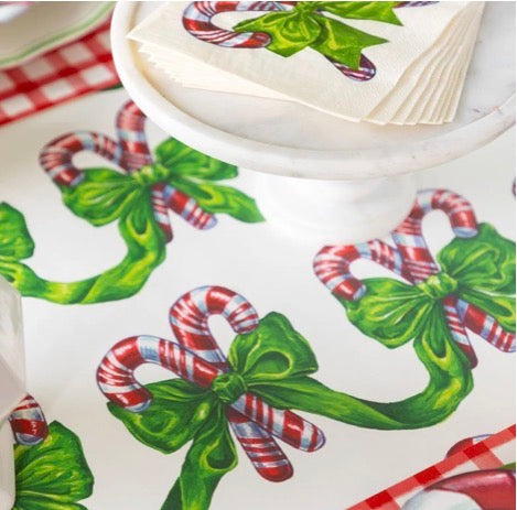 Festive Candy Canes Table Runner with candy cane and green bow pattern.