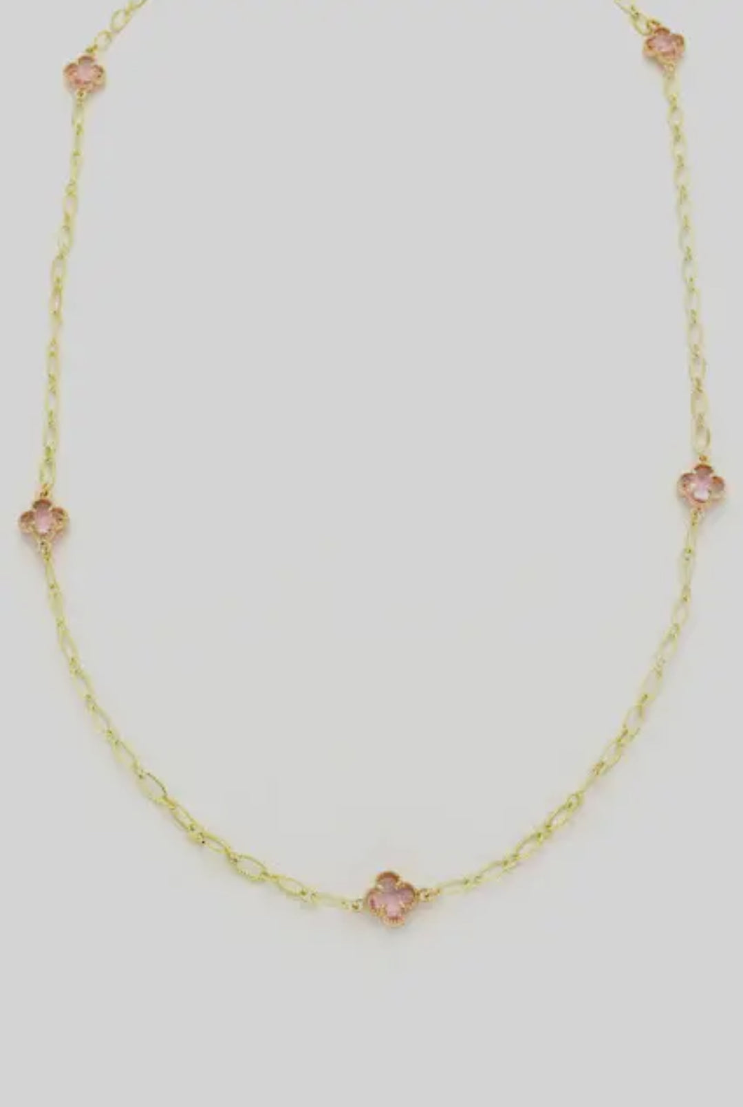 Delicate gold chain with three small pink clover-shaped stones. Available sizes: 16", 18", 20".